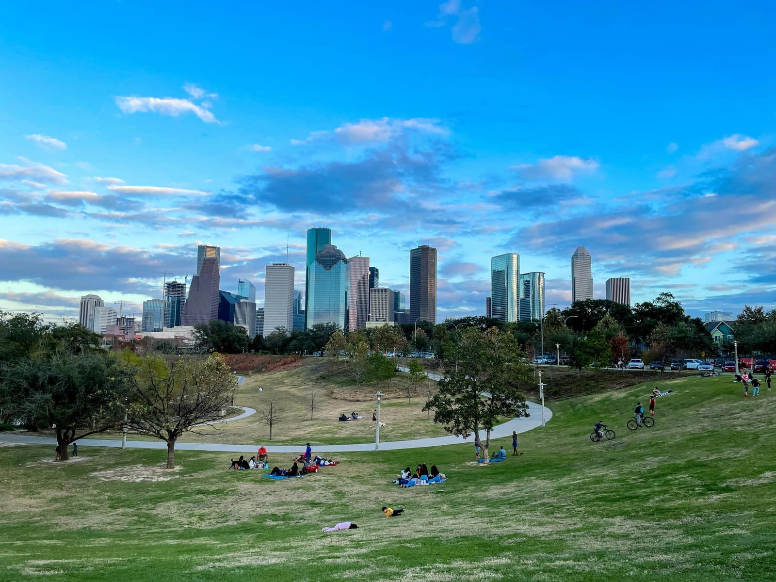 Houston skyline seen from a park, with people on the grass